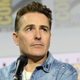 Nolan North sits on a panel at Comic-Con.